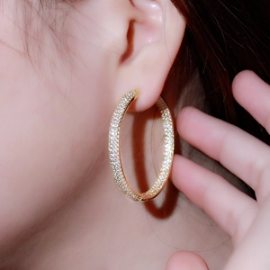 Elegant 18K gold plated hoop earrings with micro-pave cubic zirconia on a model