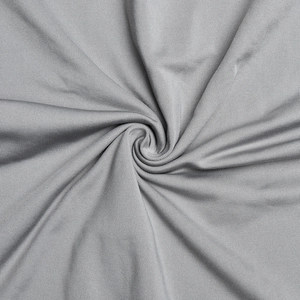 Close-up detail of grey soft high-stretch fabric showing texture and fabric folds