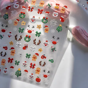 Macro detail of Christmas nail stickers with 3D embossed Santa, gingerbread, and snowflakes
