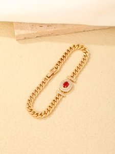 Detailed macro view of gold plated bracelet with oval red stone and white zircon stones
