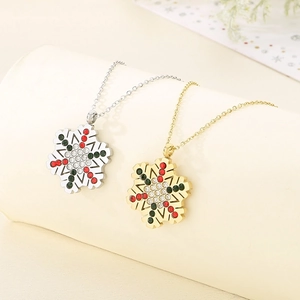 Close-up of gold and silver snowflake pendants with festive red and green rhinestones
