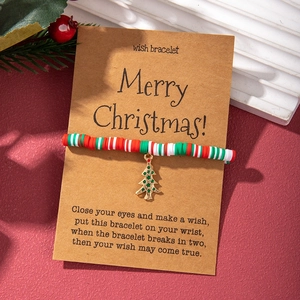 Detailed view of polymer clay Christmas wish bracelet with festive gold tree charm