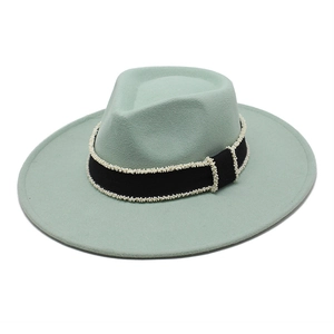 Detailed view of mint green wool fedora with a pearl-studded black grosgrain ribbon band