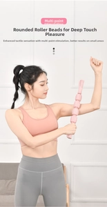 Pink foam roller stick massage roller for deep tissue muscle relief on arms and legs