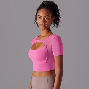 Detail of pink crop top featuring mesh stitching and hollow-out design for yoga