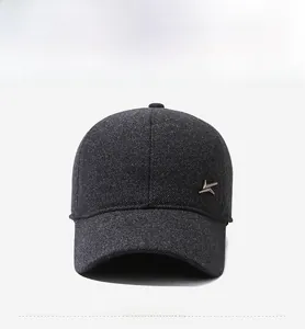 Close-up of dark grey winter baseball cap featuring twill texture and side metal emblem