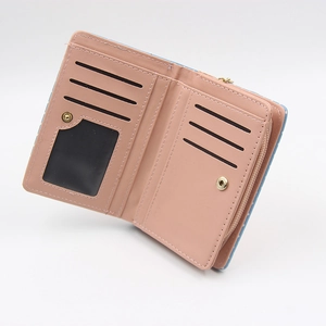 Short pink bifold wallet for women featuring polka dot patterns and card slots
