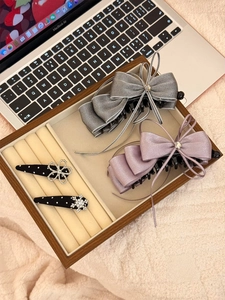 Macro view of chiffon bow hair clips with zircon star accents and silk ribbons