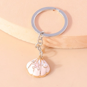 Detail of pink shell keychain with small starfish and pearl charm decoration