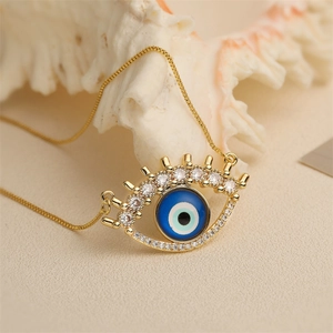 Golden Evil Eye pendant necklace with blue stones on an elegant shell background
