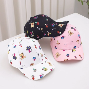 Close-up of kids' cotton baseball caps featuring cute cartoon bear and mushroom patterns
