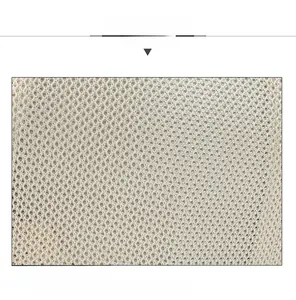 Detail view of beige breathable sandwich mesh fabric on a lightweight summer baseball cap