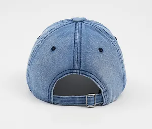 Detail view of washed denim baseball cap back with adjustable silver metal buckle closure