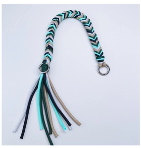 Detail view of colorful hand-woven strap with tassels and silver metal rings