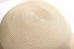 Detailed macro shot of spiral straw weave pattern on a French vintage sun hat