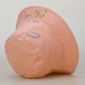 Detail of pink cotton bucket hat featuring hand-drawn blue cloud and LOVE text patterns