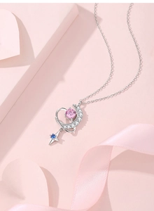 Detail of S925 silver necklace with pink round stone and blue star pendant details