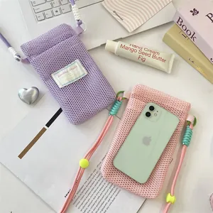 Flat lay of purple and pink mesh phone bags with colorful braided straps and cord locks