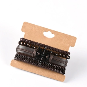 Detail of men's leather multi-layer bracelet featuring a vintage metal helm charm