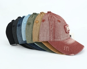 Pile of washed cotton baseball caps in various colors with NYC 3D embroidery and distressed detail
