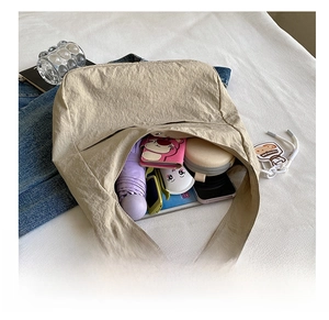 Spacious beige tote bag interior view showing umbrella, wallet, and phone storage