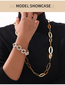 Macro detail of interlinked gold necklace and micro-pave diamond chain bracelet set