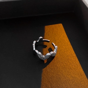 Detailed view of silver zircon heart ring with paved stones and adjustable open band