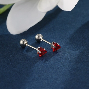 Macro detail of triangle red zircon earrings with secure screw-on ball back studs