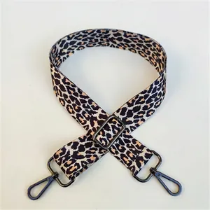 Close-up of leopard print shoulder strap with adjustable gunmetal buckle and swivel hooks