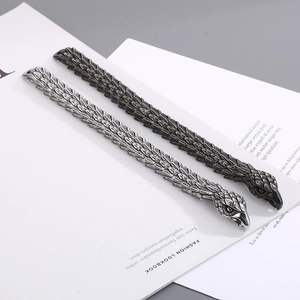 Close-up of vintage eagle head bracelets with detailed feather textures and silver finish