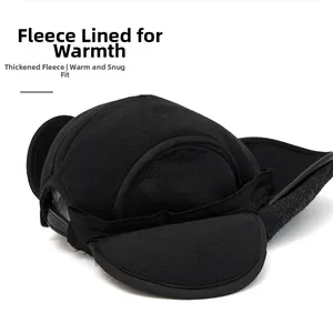 Detail of black winter newsboy hat with thick fleece lining and fold-down ear flaps