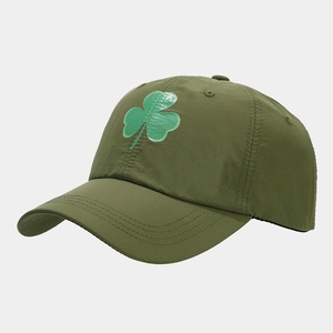 Detailed view of an olive green quick-dry baseball cap featuring a green shamrock logo
