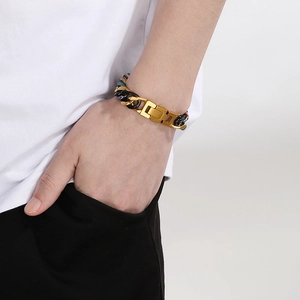 Detailed view of bicolor stainless steel chain bracelet on wrist with folding clasp