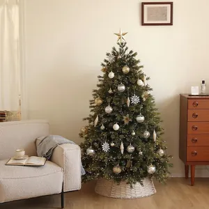 Luxurious artificial Christmas tree set with gold ornaments and woven tree skirt base