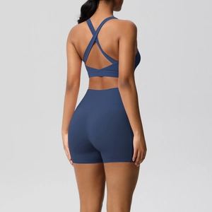 Detail of cross-back sports bra and high-waist shorts in matte blue fabric
