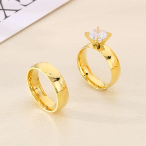 Polished 18K gold stainless steel couple rings set with a round cubic zirconia stone