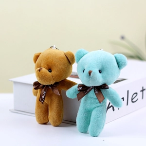 Close-up of small plush teddy bears in brown and teal with Love ribbon and bead chains