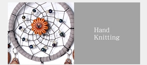 Macro view of a handmade knitted dream catcher with grey ring, beads and feathers