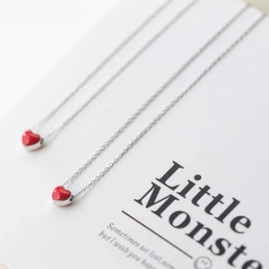 Set of two silver necklaces featuring vibrant red faceted heart-shaped pendants for women
