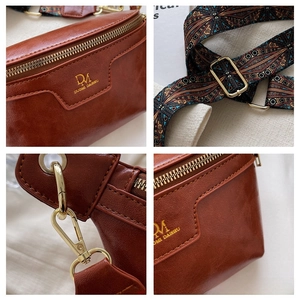 Close-up of brown leather chest bag with golden hardware and bohemian shoulder strap