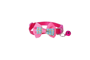 Detailed view of pink nylon pet collar with plaid bowtie, metal bell, and buckle strap