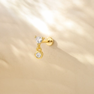 Close-up of gold S925 silver stud earring with tassel droplet and zircon stone
