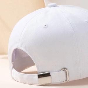 White cotton baseball cap featuring an adjustable silver metal buckle on back strap