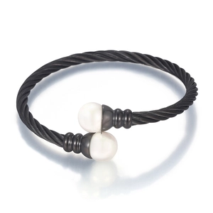 Braided steel cable bracelet in black with two white pearls on a clean white background