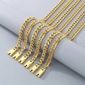 Close-up of golden stainless steel Cuban chains with unique H-shaped clasps and polished finish