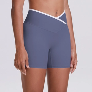 Detailed view of high-waisted yoga shorts with V-cross waist and white trim in dusty blue