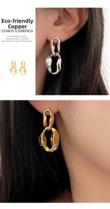 Detailed view of minimalist irregular chain earrings in gold and silver metal finishes
