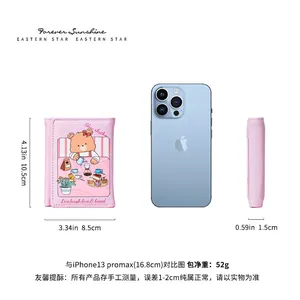Pink trifold wallet with bear print and card slots shown with smartphone for size reference