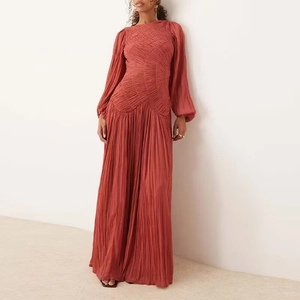 Detail of brick red long sleeve maxi dress with pleated texture and geometric paneling