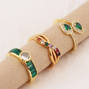 Three-piece set of gold-plated rings with colorful zircon gemstones on display stand